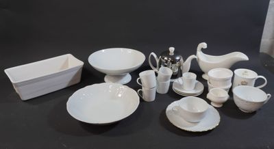 a lot of white dishes and cups on the table
