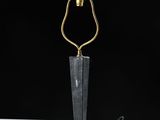 a black marble table lamp with a gold metal base