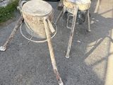 two old metal stools sitting next to a camper
