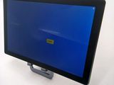 a tablet computer with a blue screen on a stand