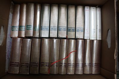 a lot of books in a box on the floor