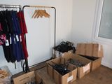 many boxes of clothes on a rack in a room