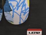 two skateboards that are hanging on the wall
