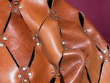 a brown leather jacket with rivets and rivets on the shoulders