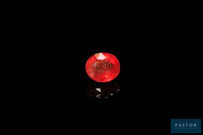 a red diamond in the dark with a reflection on the ground