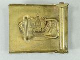 an image of a gold belt buckle with a crown on it