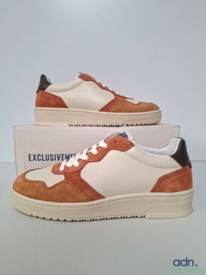 men ' s white and tan sneakers with brown trims on top of a box
