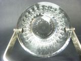 a clear glass plate with a silver handle on a table