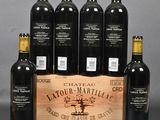 six bottles of red wine in a wooden crate on a table
