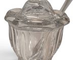 a glass jar with a spoon and spoon in it