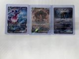 three different pokemon cards in plastic cases on a white surface