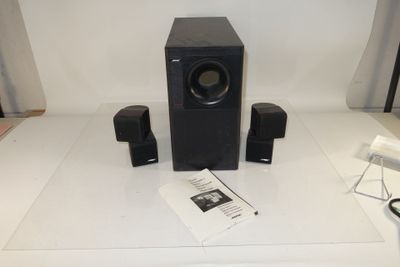 two speakers and a remote on the table