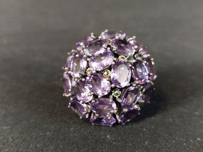 a close up of a purple ring on a black surface