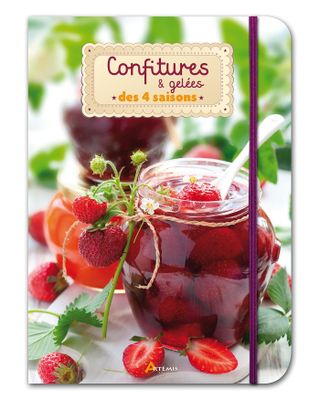 a close up of a book with strawberries and jam on it