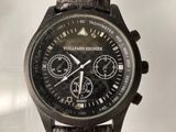 a close up of a watch with a leather strap
