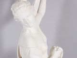 statue of a woman holding a scarf in her hands