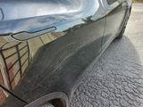 a black car parked on the side of the road