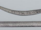 three different types of silver bracelets on a white surface