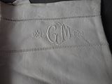 a close up of a white cloth with a monogram on it