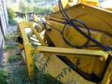 a large yellow machine that is sitting in the grass