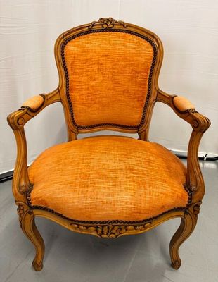 a chair with an orange upholstered seat and a wooden frame