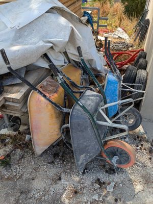 a pile of junk on the ground next to a building