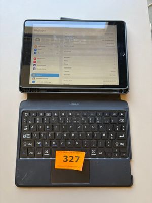 a tablet computer sitting on top of a laptop computer