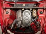 an overhead view of a red car with a engine in it ' s trunk