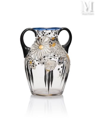 a glass vase with a black handle on a white surface