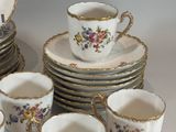 a lot of cups and saucers that are sitting on a table