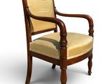 an image of a wooden chair with a beige upholstered seat