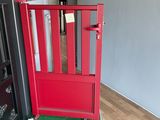 a red door with a green mat in the middle of it