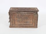 an old metal box sitting on top of a white surface