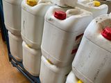 many white jugs stacked on a blue cart