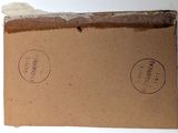 a brown box with two stamps on it sitting on a table