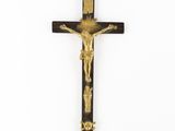 a wooden crucif with a gold cross on it