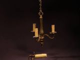 une paire de chandeliers anciens en laiton, avec des bougies suspendues à une chaîne