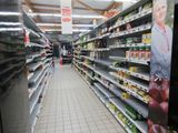 a picture of a grocery store aisle with shelves of food