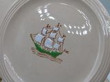 a white plate with a picture of a ship on it