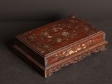 an old wooden box sitting on top of a black surface