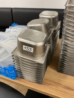 many pans of food sitting on a tray on a table
