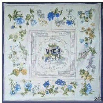 broderie au point de croix représentant un cheval et une calèche, agrémentée de fleurs bleues