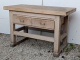 a wooden table with two drawers on top of it