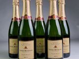 four bottles of champagne are lined up in a row