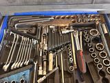 a tool box full of tools sitting on a table