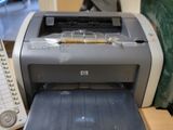 a printer sitting on a desk next to a phone