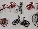 many different types of bicycles on display on a table