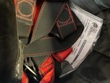 a black bag with a red and black tie and a black bag with a red and black tie and a black bag with a red and white tag