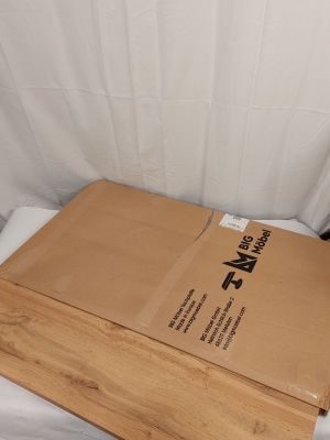 a box that is sitting on a bed next to a pillow