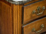 a marble top on a wooden dresser in a room